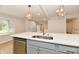 Island with a sink and dishwasher is showcased in this open kitchen at 11708 Rolling Springs Dr, Carmel, IN 46033