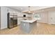 Bright kitchen with stainless steel appliances, a large island, and modern finishes at 11708 Rolling Springs Dr, Carmel, IN 46033