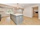 Open kitchen with an island, quartz countertop, and modern lighting fixtures at 11708 Rolling Springs Dr, Carmel, IN 46033