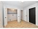 Bright laundry room with gray cabinets, light wood floors, and black interior doors at 11708 Rolling Springs Dr, Carmel, IN 46033