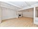 Empty living room featuring a fireplace, built-in shelving, recessed lighting, and hardwood floors at 11708 Rolling Springs Dr, Carmel, IN 46033