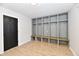 Mudroom features built-in cubbies with hooks, seating, light wood floors, and a black entry door at 11708 Rolling Springs Dr, Carmel, IN 46033