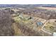 Aerial view of homes in a suburban area surrounded by bare trees and roads at 1194 S 300 E, Anderson, IN 46017