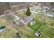 A high-angle aerial view shows a home with a patio and well-kept lawn at 1194 S 300 E, Anderson, IN 46017