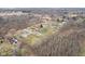 Sprawling aerial view of a neighborhood surrounded by trees at 1194 S 300 E, Anderson, IN 46017