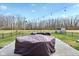 View of the patio, outdoor seating, and black fence surrounding the back yard at 1194 S 300 E, Anderson, IN 46017