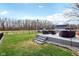 View of the back yard with a patio, outdoor seating and a black aluminum fence at 1194 S 300 E, Anderson, IN 46017