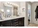 This primary bathroom has a double sink vanity, vanity mirror, and a bright window at 1194 S 300 E, Anderson, IN 46017
