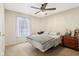 This bedroom has a bright window, neutral walls, and a ceiling fan at 1194 S 300 E, Anderson, IN 46017