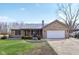 Charming brick home with a metal roof, two car garage, and well-manicured lawn at 1194 S 300 E, Anderson, IN 46017