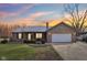 Charming brick home with an attached two-car garage and well-kept lawn at 1194 S 300 E, Anderson, IN 46017