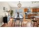 Bright eat-in kitchen with wood cabinets, stainless appliances, and a modern chandelier at 1194 S 300 E, Anderson, IN 46017