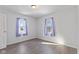 Bedroom with hardwood floors and natural light streaming through two windows at 1196 S Vinewood Ave, Indianapolis, IN 46241