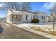 Charming single-story home with gray siding and a cozy front porch with black shutters at 1196 S Vinewood Ave, Indianapolis, IN 46241