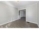 Open living room with hardwood floors and neutral paint, creating a bright and airy atmosphere at 1196 S Vinewood Ave, Indianapolis, IN 46241