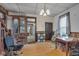 Spacious dining room with stairs, wooden cabinets, and vintage chandelier at 125 Kansas St, Indianapolis, IN 46225