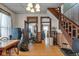 Spacious dining room features wood paneling and staircase that leads to the upper level at 125 Kansas St, Indianapolis, IN 46225