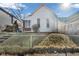 Charming home with a gabled roof, set on a raised yard with a chain-link fence at 125 Kansas St, Indianapolis, IN 46225