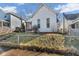 Charming home with a gabled roof, set on a raised yard with a chain-link fence at 125 Kansas St, Indianapolis, IN 46225