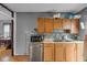 Kitchen with wood cabinets, stainless steel appliances, mosaic backsplash and updated fixtures at 125 Kansas St, Indianapolis, IN 46225