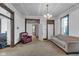 Bright living room with a neutral-toned sofa and a red leather chair at 125 Kansas St, Indianapolis, IN 46225