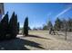 Expansive backyard with mature trees, a playset, and a gently sloping lawn for outdoor activities at 12650 Misty Ridge Ct, Fishers, IN 46037