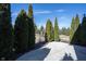 Landscaped backyard featuring mature trees, a playset, and a paved patio area for outdoor enjoyment at 12650 Misty Ridge Ct, Fishers, IN 46037