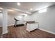Finished basement with a treadmill, kitchenette area, wood-look floors, and recessed lighting at 12650 Misty Ridge Ct, Fishers, IN 46037