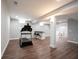 Finished basement featuring modern floors, exercise equipment, and a convenient wet bar area at 12650 Misty Ridge Ct, Fishers, IN 46037