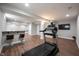 Finished basement with a treadmill, kitchenette bar area, wood-look floors, and recessed lighting at 12650 Misty Ridge Ct, Fishers, IN 46037