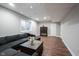 Relaxing basement with plush sectional sofa, wood flooring, and bright natural light at 12650 Misty Ridge Ct, Fishers, IN 46037