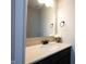 Neutral powder room featuring modern fixtures, a stone counter, and a decorative flower arrangement at 12650 Misty Ridge Ct, Fishers, IN 46037