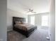 Primary bedroom featuring a large bed, soft carpeting, neutral walls, and ample natural light at 12650 Misty Ridge Ct, Fishers, IN 46037