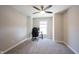 Bright bedroom with neutral walls and carpet, featuring a window, ceiling fan and a desk at 12650 Misty Ridge Ct, Fishers, IN 46037