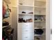 A white walk-in closet with built-in shelving and drawers providing ample storage space at 12650 Misty Ridge Ct, Fishers, IN 46037