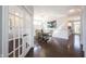 Open dining room featuring hardwood floors and a view through glass doors at 12650 Misty Ridge Ct, Fishers, IN 46037
