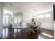 Open-concept dining room with hardwood floors, modern lighting, and easy access to entry at 12650 Misty Ridge Ct, Fishers, IN 46037