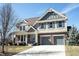 Two-story home featuring a two-car garage, brick accents, and a well-manicured lawn at 12650 Misty Ridge Ct, Fishers, IN 46037
