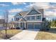 Two-story home featuring a two-car garage, brick accents, and a well-manicured lawn at 12650 Misty Ridge Ct, Fishers, IN 46037