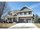 Two-story home featuring a two-car garage, brick accents, and a well-manicured lawn at 12650 Misty Ridge Ct, Fishers, IN 46037