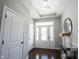 Bright foyer featuring dark hardwood floors, a decorative mirror, and a modern light fixture at 12650 Misty Ridge Ct, Fishers, IN 46037