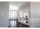 Hallway with French doors to office and entry featuring hardwood floors and crown molding at 12650 Misty Ridge Ct, Fishers, IN 46037
