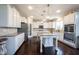 Bright and open kitchen featuring white cabinets, granite countertops, and stainless appliances at 12650 Misty Ridge Ct, Fishers, IN 46037