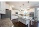 Modern white kitchen with granite countertops, stainless steel appliances, and island at 12650 Misty Ridge Ct, Fishers, IN 46037