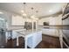 Bright kitchen with white cabinetry, granite countertops, large island, and stainless steel appliances at 12650 Misty Ridge Ct, Fishers, IN 46037