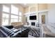 Bright, open-concept living area with vaulted ceilings, fireplace, and hardwood floors at 12650 Misty Ridge Ct, Fishers, IN 46037