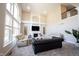Spacious living room with fireplace, large windows, and vaulted ceiling at 12650 Misty Ridge Ct, Fishers, IN 46037