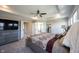 Spacious main bedroom with tray ceilings, a ceiling fan, and an ensuite bathroom at 12650 Misty Ridge Ct, Fishers, IN 46037
