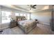 Comfortable main bedroom featuring tray ceilings, large windows, and a ceiling fan at 12650 Misty Ridge Ct, Fishers, IN 46037