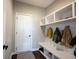 Functional mudroom featuring built-in storage, coat hooks, and a convenient bench at 12650 Misty Ridge Ct, Fishers, IN 46037